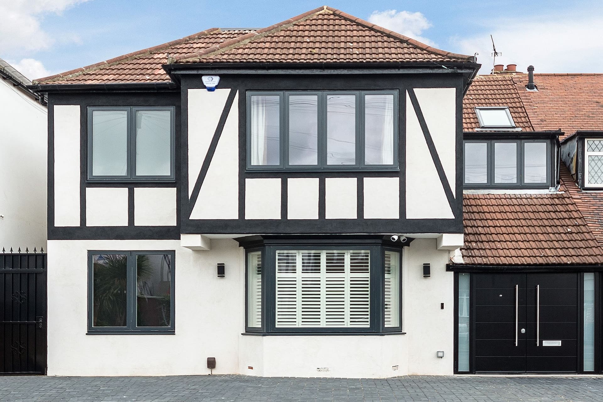 house-extension-gantshill-facade-double-front-door-white-render-black-details.jpeg